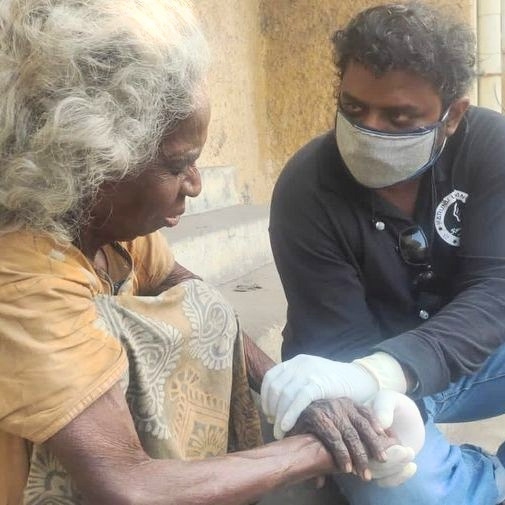 A KUT caregiver counselling a rescued resident with warmth and patience